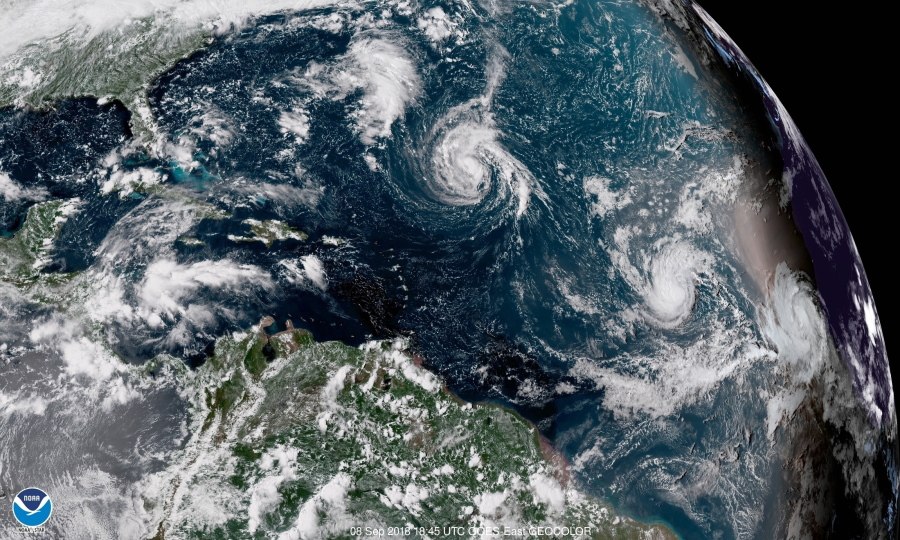 This enhanced satellite image made available by NOAA shows Tropical Storm Florence, center, in the Atlantic Ocean on Saturday, Sept. 8, 2018 at 2:45 p.m. EDT.