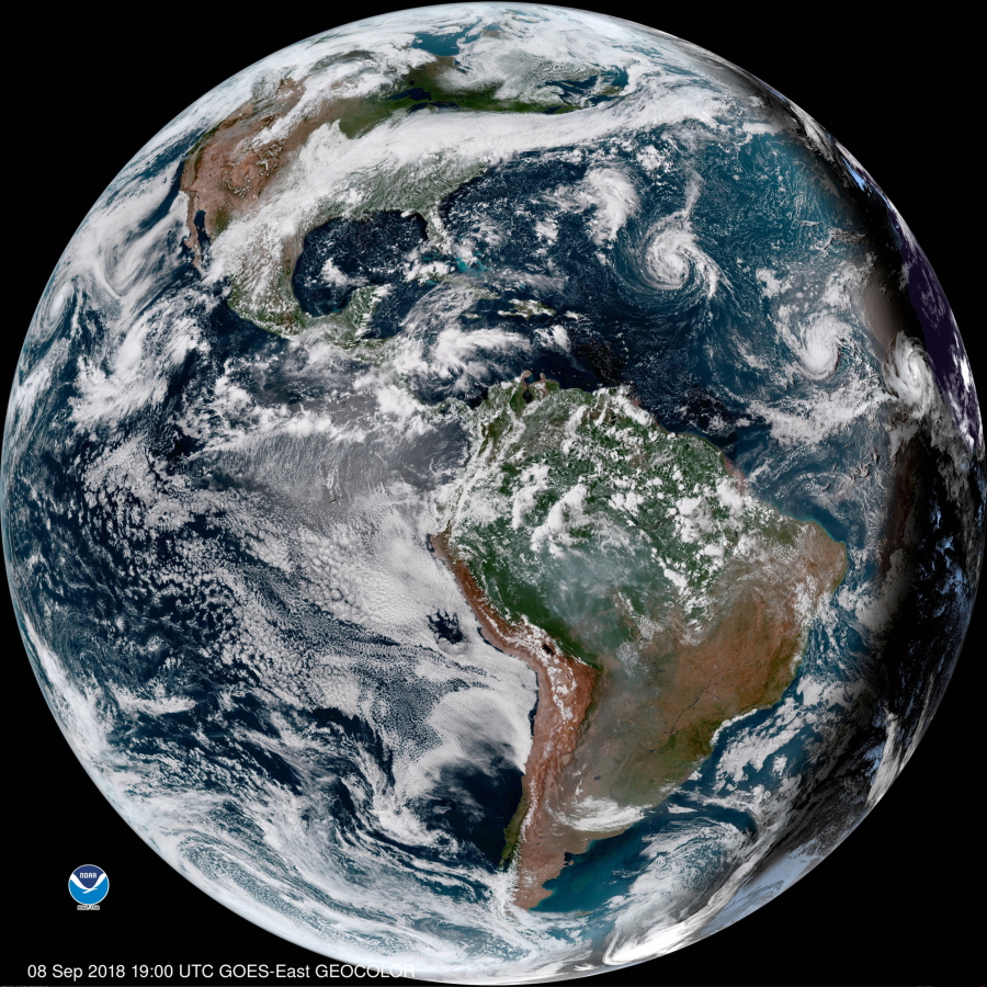 This enhanced satellite image made available by NOAA shows Tropical Storm Florence, third from right, in the Atlantic Ocean on Saturday, Sept. 8, 2018 at 3 p.m. EDT. At right, off the coast of Africa is Tropical Storm Helene, and second from right is Tropical Depression 9.