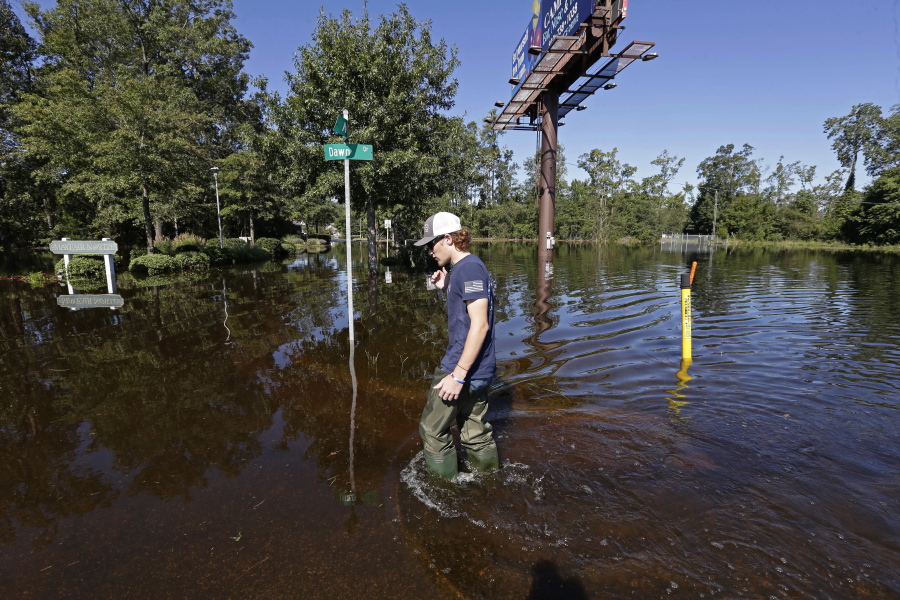Zachary Conner wades into a flooded neighborhood to check on his girlfriend in Lumberton, N.C., on Tuesday, following the effects from Hurricane Florence.