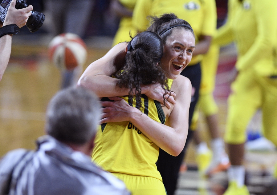 Seattle Storm forward Breanna Stewart, back, celebrates and hugs guard Sue Bird (10) after Game 3 of the WNBA basketball finals against the Washington Mystics, Wednesday, Sept. 12, 2018, in Fairfax, Va. The Storm won 98-82.