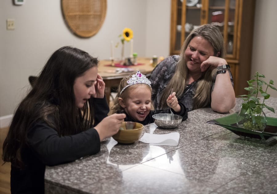 Lacey Wescom, 12, from left, her sister Tillie Thornber, 3, and their mother Wendi Thornber eat ice cream together on Sept. 19 at their home in Hazel Dell. The family used to be homeless, but has made significant strides. This summer Wendi Thornber graduated from Clark College and began a full-time job with PeaceHealth.
