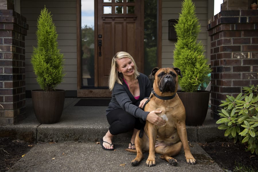 Irene Gielen and her bull mastiff, Alice, are pictured at her home in Vancouver on Sept. 11. Gielen tested positive for the BRCA1 gene in 2016 and since then has had multiple surgeries to reduce her risk of cancer. Gielen had a double mastectomy first and is currently healing from getting her ovaries and fallopian tubes removed in late August.