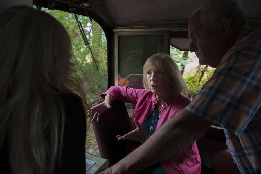 Eileen Quiring chats about her plans for a rail development that she hopes will create good-paying jobs, while on a tour of the Chelatchie Prairie Railroad. Dave Nelson, right, a Clark County Railroad Advisory Board member, surveys the line.