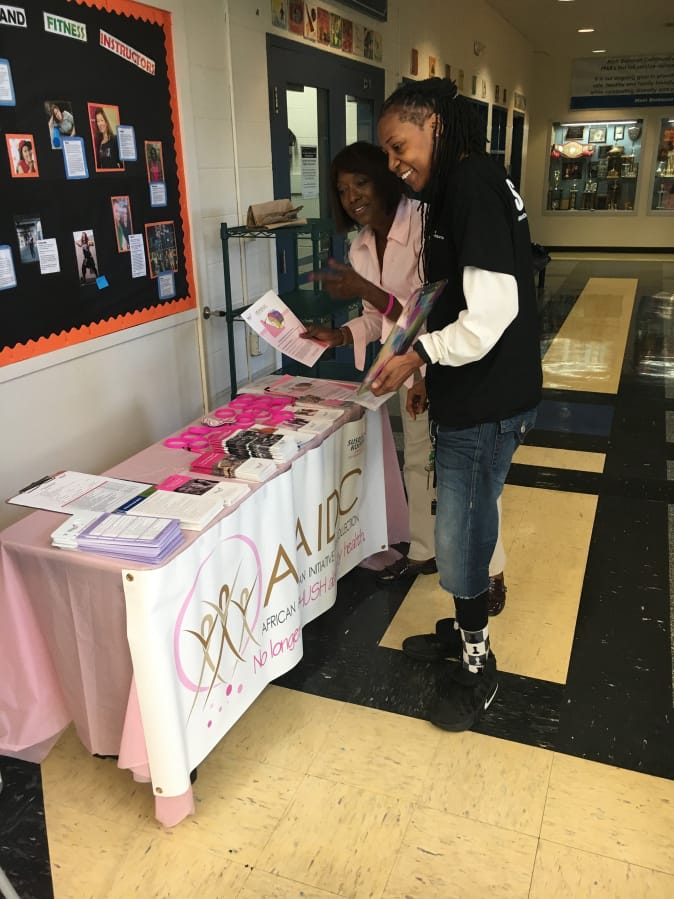 D. Bora Harris, left, interacts with a community member at Matt Dishman Community Center in Portland as part of an initiative to help reduce the breast cancer rate of mortality for African-American women.