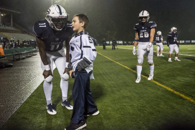 Skyview's Jalynnee McGee, left, chats with a Skyview ball boy after McGee ran a pick six against Union at the Kiggins Bowl on Friday night, Oct.