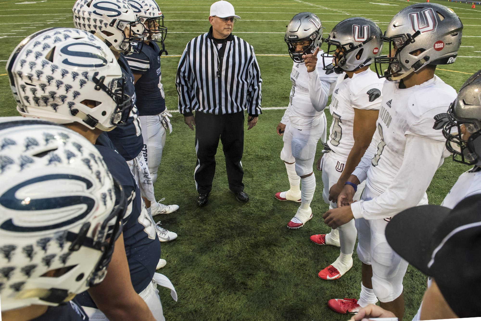 Union's Lincoln Victor, center right, choses the team's defending goal following the coin toss against Skyview at the Kiggins Bowl on Friday night, Oct.