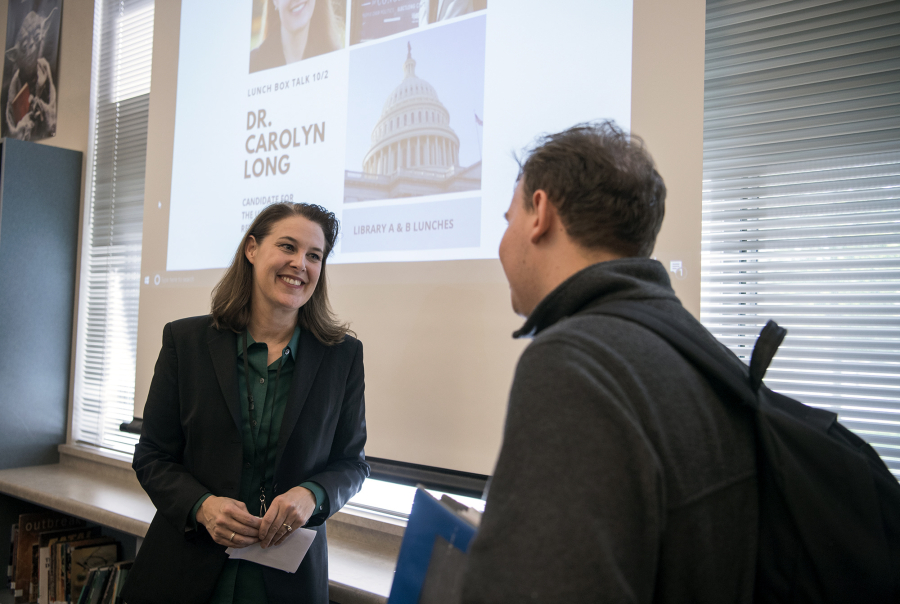 Carolyn Long, a Democrat running for the 3rd Congressional District, speaks with Camas High School senior Parker Shaw after students gathered to hear Long speak during the DECA Girls Represent lunchtime series event on Tuesday.
