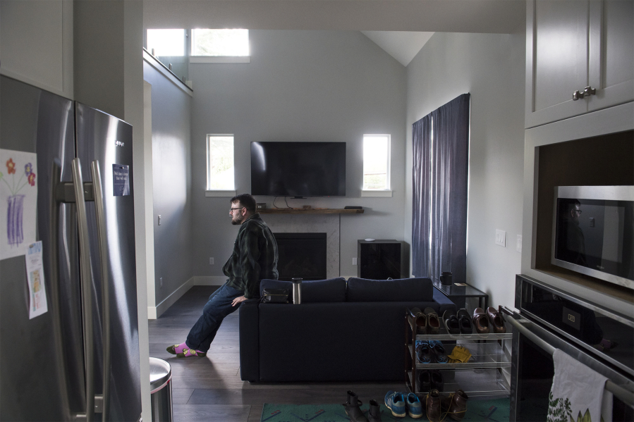 Tristan Graham, 32, sits on his couch in his new accessory dwelling unit, which was built in his parents’ backyard near Five Corners. Construction took five months.