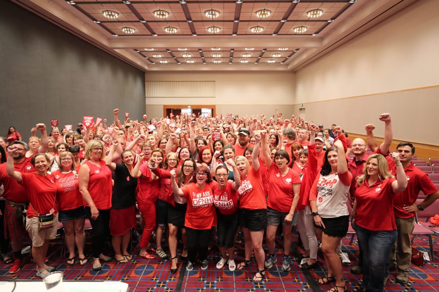 Members of the Oregon Federation of Nurses & Health Professionals celebrate before the ratification of a three-year collective bargaining agreement with Kaiser Permanente.