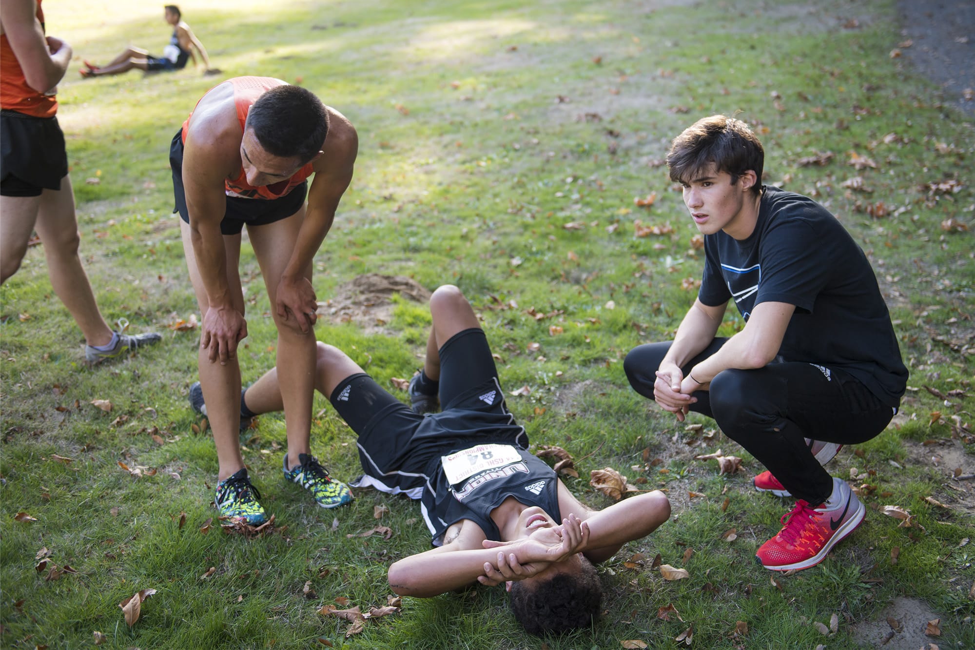 Battle Ground Runner Kyle Ganoung, from left, and Union Runner Andres Solorzano recover from their race with Union Alternate Runner Jaxon Milligan during the Boys 4A District Cross Country Championships at Lewisville Park on Thursday, afternoon, Oct. 18, 2018.