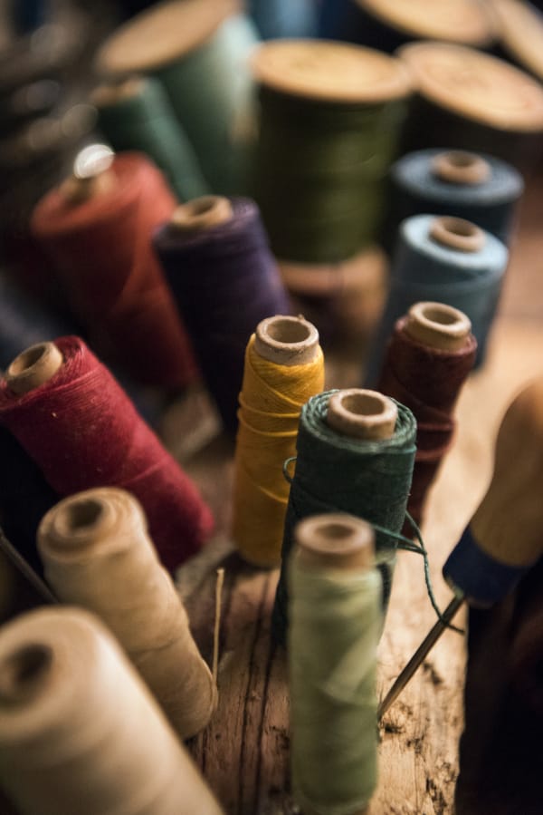 An array of linen threads used for leather products sit on Kathleene Kavanagh’s work table.