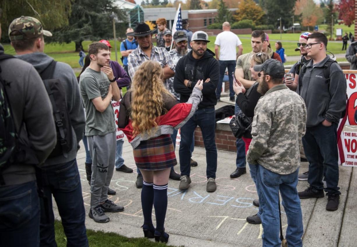 Patriot Prayer leader Joey Gibson and his supporters talk with members of the crowd before he gives a speech Wednesday at Clark College. After the college canceled classes Monday in response to Patriot Prayer’s demonstration on campus, the group returned Wednesday to protest Initiative 1639 and spread its message to students.