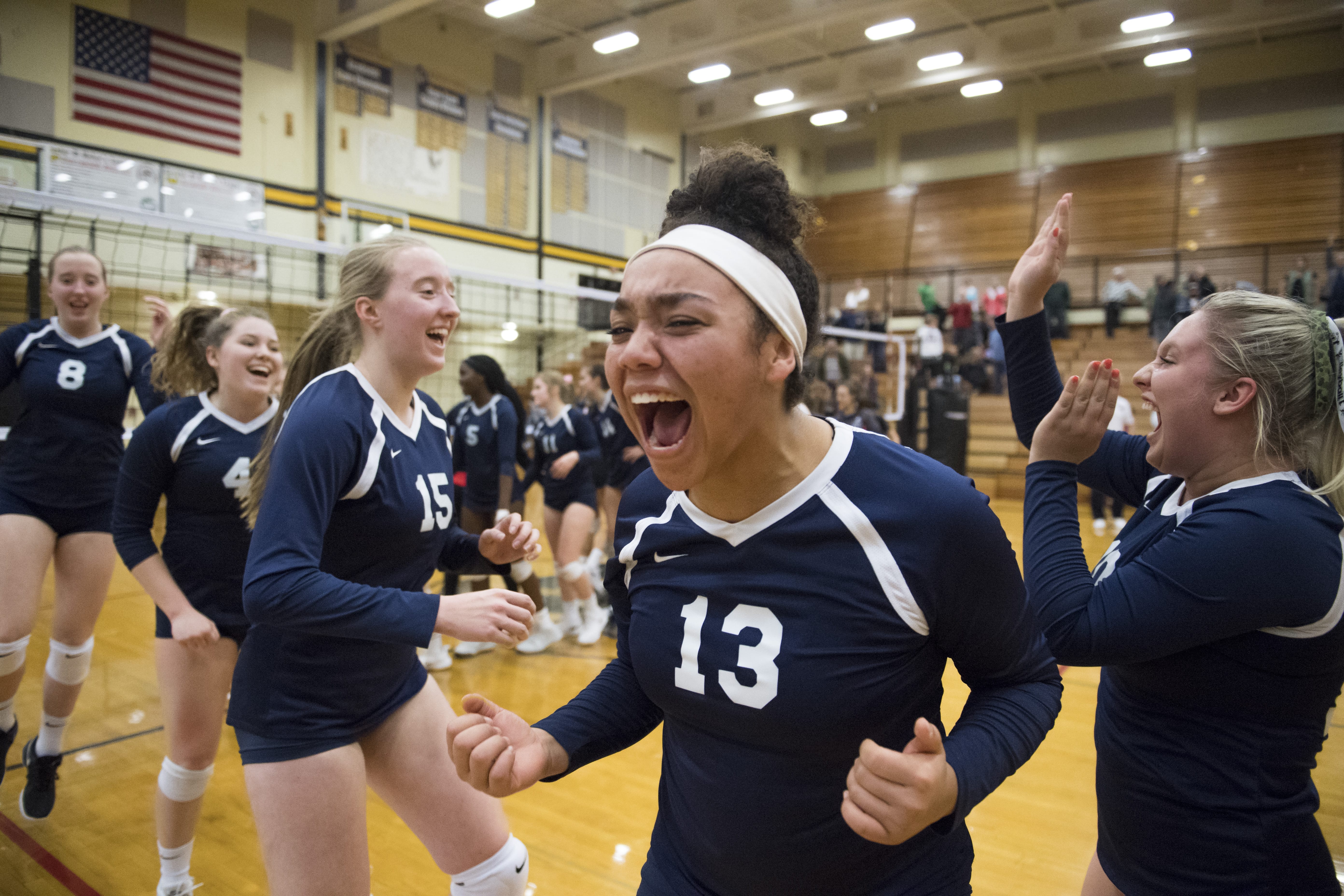Skyview's Tyra Schaub (center right) celebrates with her team following a victory over Camas at Hudson's Bay High School on Tuesday night, Oct. 30, 2018.