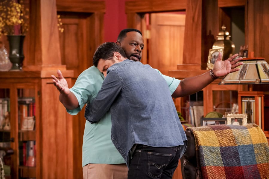 Cedric the Entertainer, who plays Calvin Butler, gets a hug from Max Greenfield as Dave Johnson, in “The Neighborhood.” Bill Inoshita/CBS