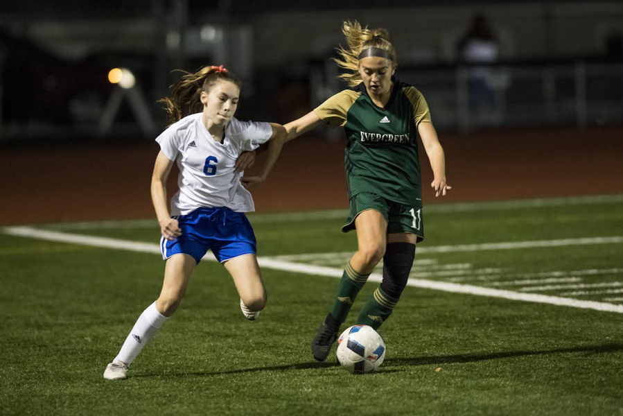 Mountain View’s midfielder Taylor Armstrong competes with Evergreen’s Leiah Keniston at McKenzie Stadium.