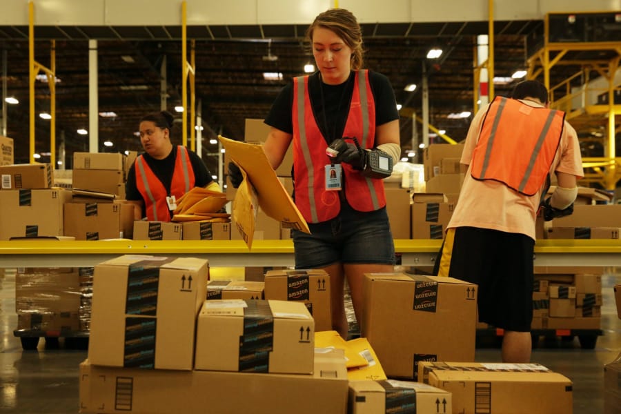 Chelsea Pfeiffer scans items at Amazon’s sortation center in Kent.
