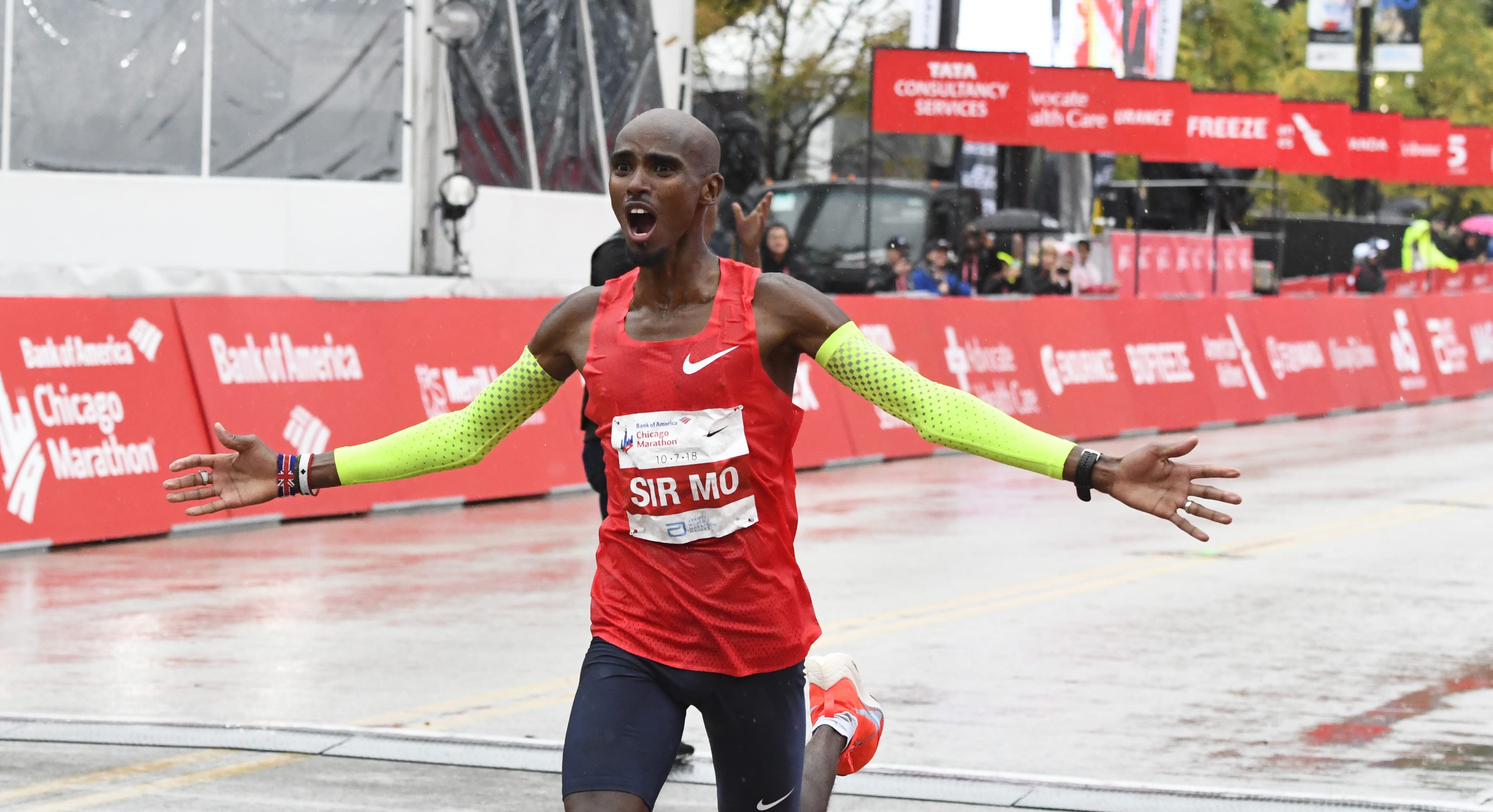 Mo Farah, of Britain, raises his arms after finishing in first place during the Bank of America Chicago Marathon, Sunday, Oct. 7, 2018, in Chicago.