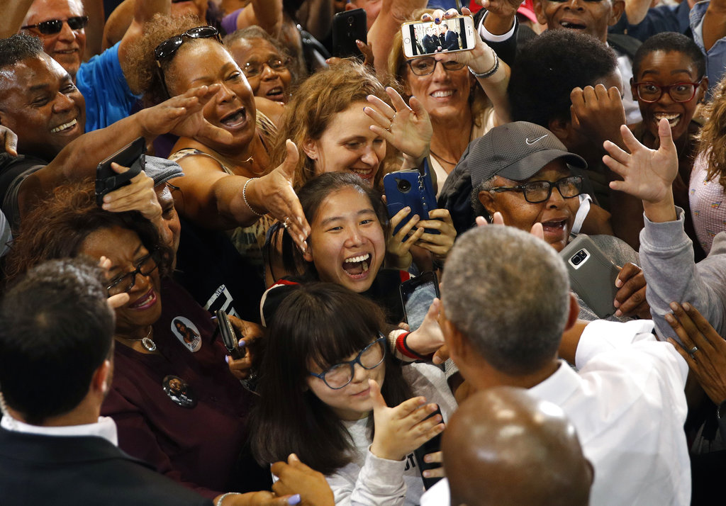 People clamor to shake hands with Former President Barack Obama at a rally in support of candidate for Senate Jacky Rosen and other Nevada Democrats, Monday, Oct. 22, 2018, in Las Vegas.