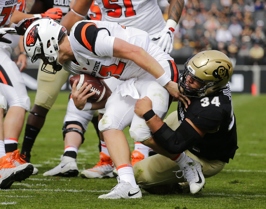 Colorado defensive lineman Mustafa Johnson (34) sacks Oregon State quarterback Jack Colletto (12) during the first half of an NCAA college football game, Saturday, Oct. 27, 2018, in Boulder, Colo.