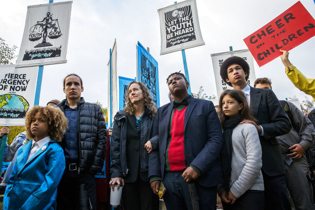 Julia Olson, chief legal counsel for Our Children's Trust, third from left, stands with some of the 21 youth plaintiffs she is representing during a rally in Eugene, Ore., Monday, Oct. 29, 2018, to support a high-profile climate change lawsuit against the federal government. Trial was set to begin in federal court in Eugene Monday morning. But the U.S. Supreme Court temporarily halted the proceedings to decide whether the case should move forward.