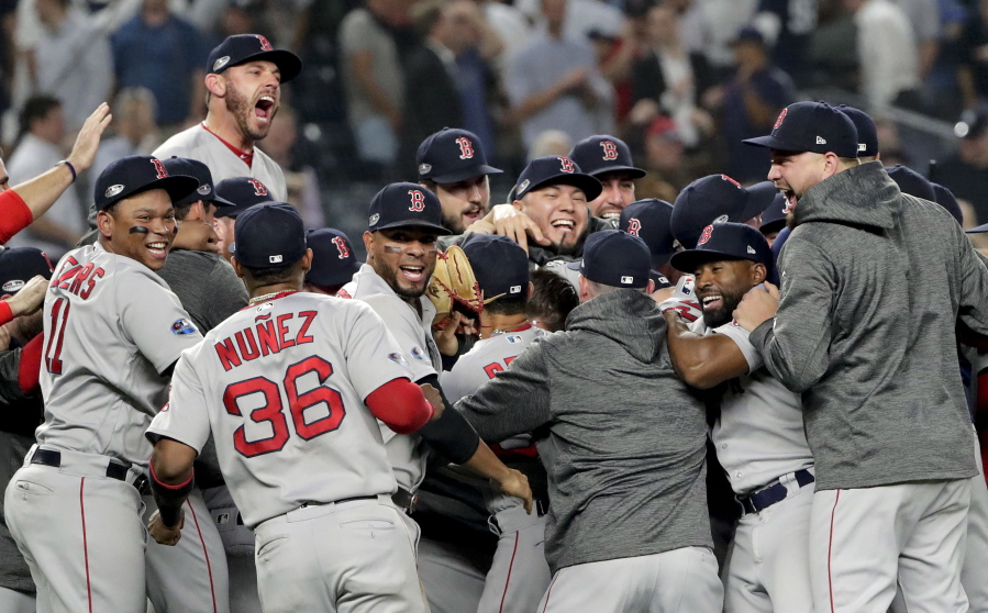 The Boston Red Sox celebrate after beating the New York Yankees 4-3 in Game 4 of baseball’s American League Division Series, Tuesday, Oct. 9, 2018, in New York.