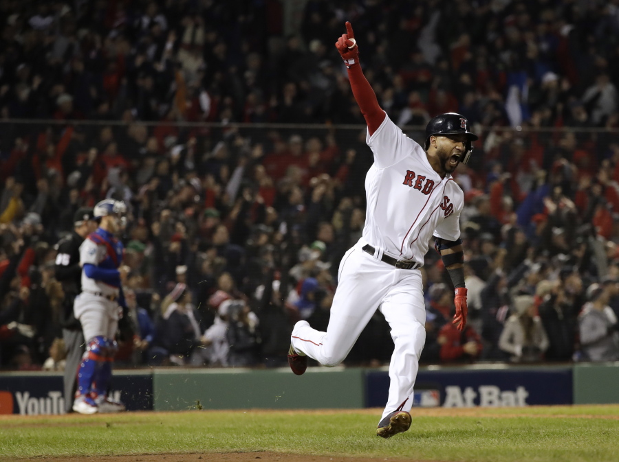 Boston Red Sox’s Eduardo Nunez reacts after hitting a three-run home run during the seventh inning of Game 1 of the World Series baseball game against the Los Angeles Dodgers Tuesday, Oct. 23, 2018, in Boston. (AP Photo/David J.