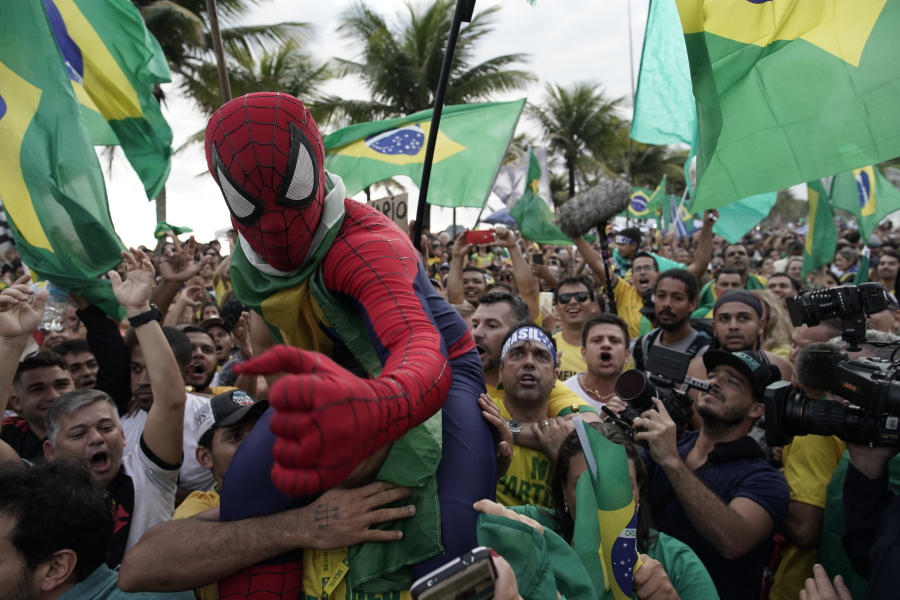 Supporters of Brazilian presidential candidate Jair Bolsonaro cheer as they gather outside his residence to wait for election runoff results, in Rio de Janeiro, Brazil, Sunday, Oct. 28, 2018. Brazilian voters decide who will next lead the world’s fifth-largest country, the left-leaning Fernando Haddad of the Workers’ Party, or far-right rival Bolsonaro of the Social Liberal Party.