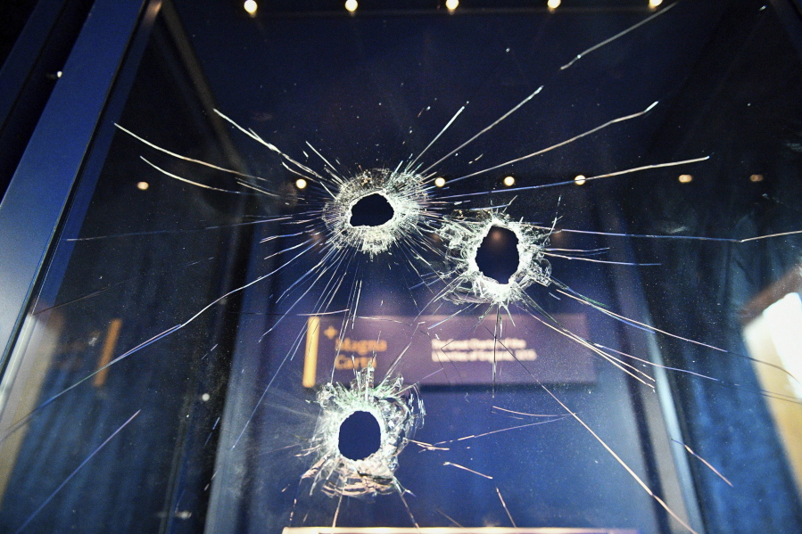 Holes made by a hammer mar the glass case that housed the Magna Carta on Friday at Salisbury Cathedral in Salisbury, England.