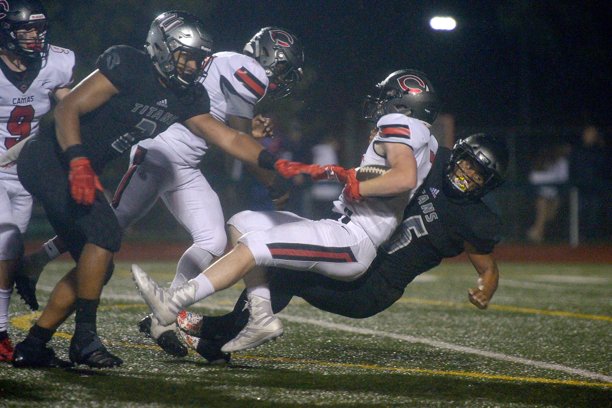 Union's Lincoln Victor takes down a Camas punt returner (7) at McKenzie Stadium in Vancouver on Friday, October 26, 2018. Union beat Camas 14-7.