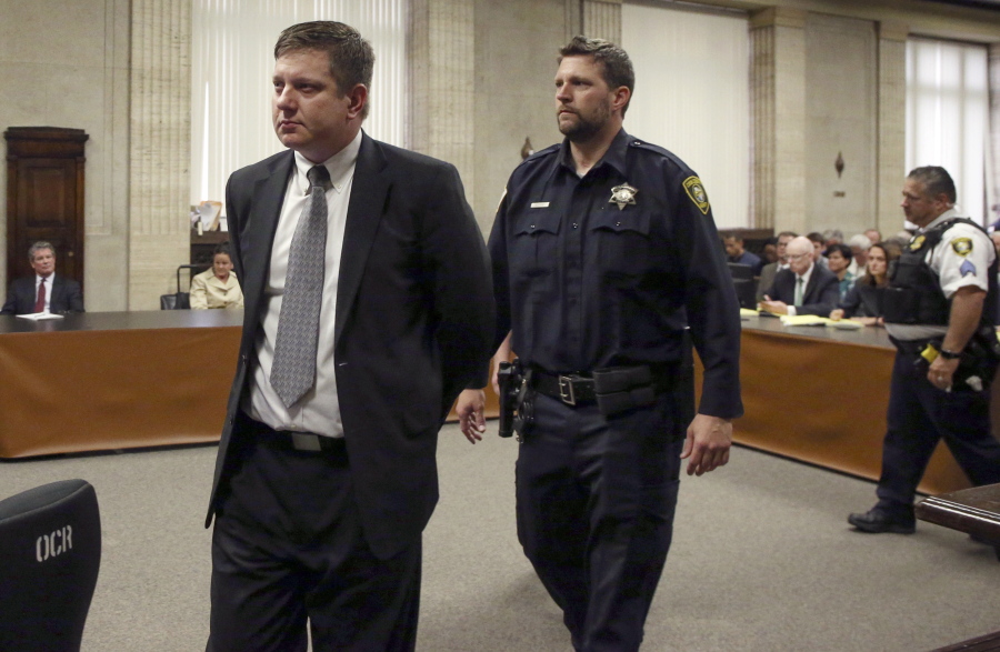 Chicago police Officer Jason Van Dyke, left, is taken into custody Friday at the Leighton Criminal Court Building in Chicago after jurors found him guilty of second-degree murder and aggravated battery in the 2014 shooting of Laquan McDonald.