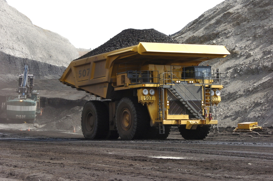 FILE - In this April 4, 2013, file photo, a mining dumper truck hauls coal at Cloud Peak Energy’s Spring Creek strip mine near Decker, Mont. The Trump administration is considering using West Coast military bases or other federal properties as transit points for shipments of U.S. coal and natural gas to Asia.