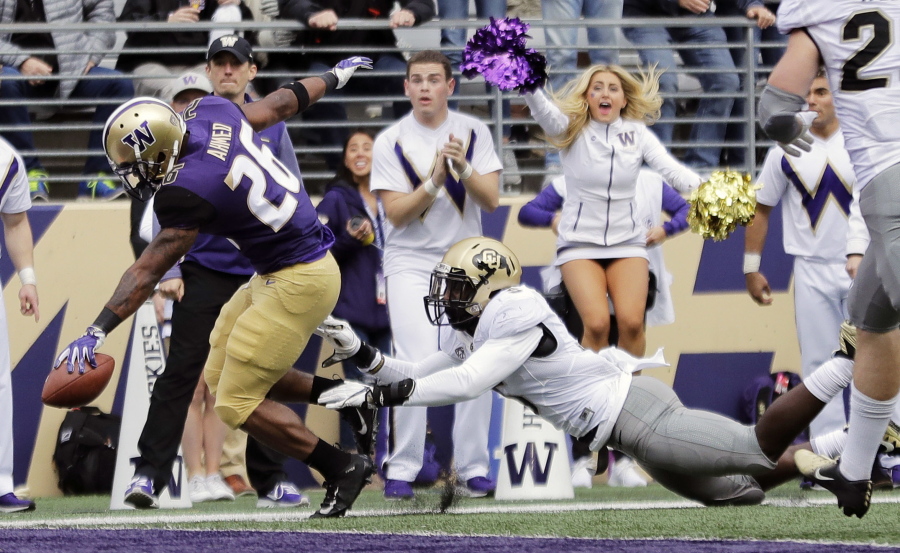Washington running back Salvon Ahmed, left, scores a touchdown ahead of Colorado linebacker Davion Taylor during the first half of an NCAA college football game, Saturday, Oct. 20, 2018, in Seattle. (AP Photo/Ted S.
