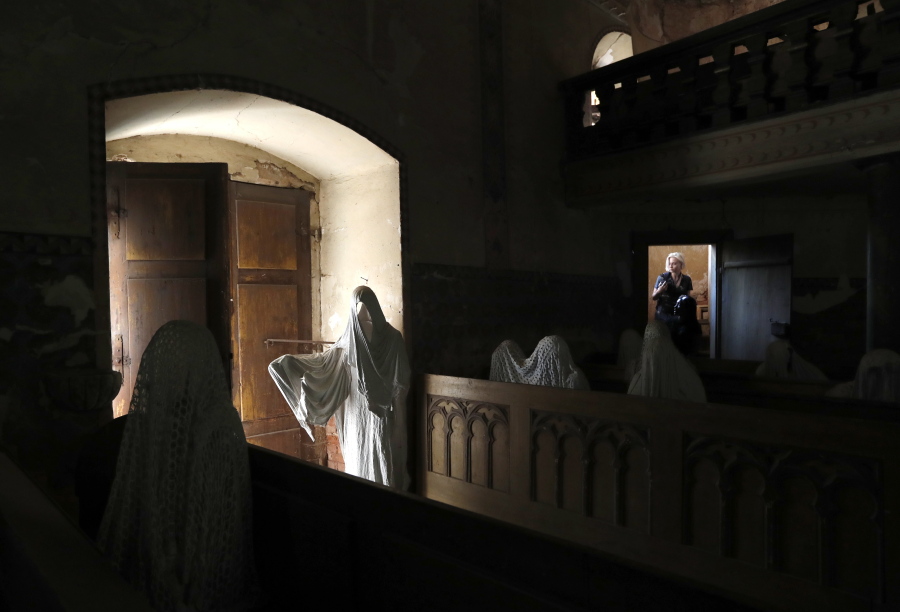 French tourists visit the church of Saint George in the village of Lukava, Czech Republic. In the year of 2012 the art student Jakub Hadrava filled the church’s pews with ghostly figures, made from plaster casts of live models draped in white cloth. The effect is chilling.