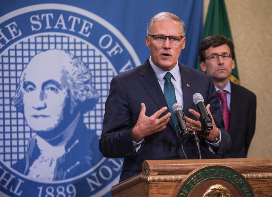 Gov. Jay Inslee addresses a news conference Thursday in Olympia with Attorney General Bob Ferguson following an earlier announcement that Washington’s Supreme Court struck down the state’s death penalty.