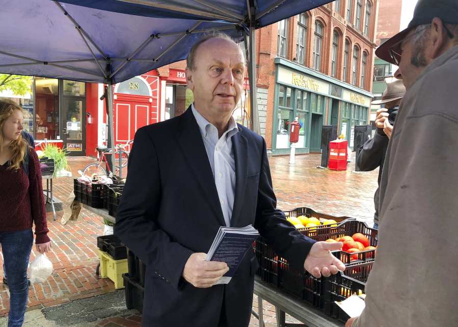 Independent candidate for governor, economic consultant Alan Caron talks to voters at a farmers market in Portland, Maine. Caron will face Democrat Janet Mills, Republican Shawn Moody and independent candidate Terry Hayes in the November general election.