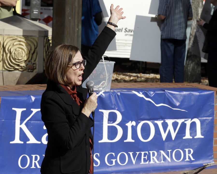 FILE - In this Oct. 17, 2018 file photo, Oregon Democratic Gov. Kate Brown speaks during a rally in Portland, Ore., Wednesday, Oct. Brown is seeking re-election in a tight race against Republican Knute Buehler.