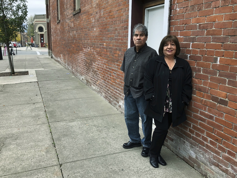 Delmiro Trevino and his wife, Oralia, pose Tuesday in front of a building in Independence, Ore., where the Hi-Ho restaurant used to be. It was in that restaurant, in 1977, that Delmiro Trevino was in when three sheriff’s deputies and a policewoman came in and demanded he show documents proving he was American. The racial profiling of Trevino, an American born in Texas, led to Oregon becoming America’s first sanctuary state.