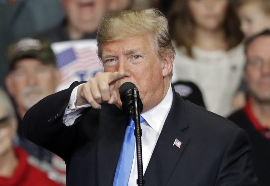 In this Oct. 26, 2018 photo, President Donald Trump points to the media as he speaks during a campaign rally in Charlotte, N.C.