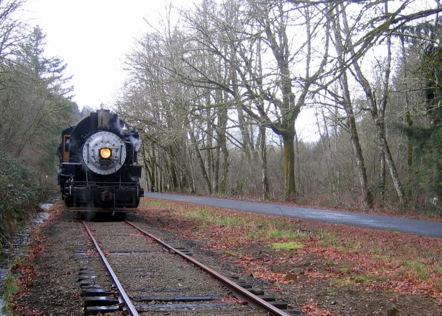 A train chugs down the Chelatchie Prairie Railroad .