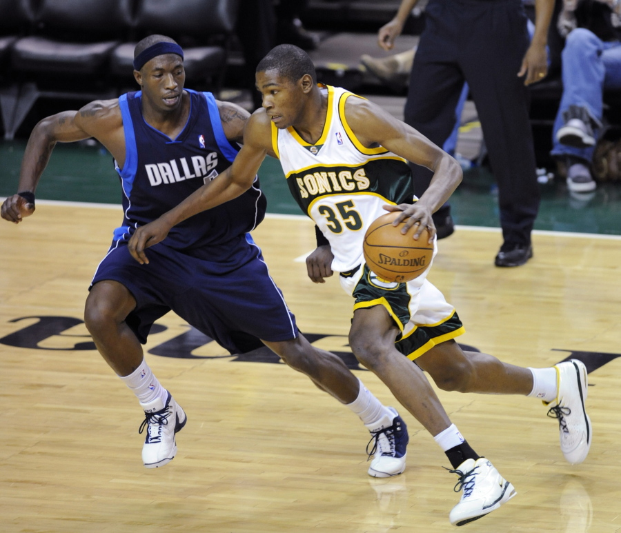 From 2008, Seattle SuperSonics' Kevin Durant (35) tries to drive past Dallas Mavericks' Josh Howard during an NBA game at KeyArena in Seattle. KeyArena is getting an appropriate send off Friday, Oct. 5, 2018, with an NBA game being played once again under its roof as the former home of the SuperSonics will see the Golden State Warriors meet the Sacramento Kings in a preseason game. Afterward, the building will be shuttered and remodeled.