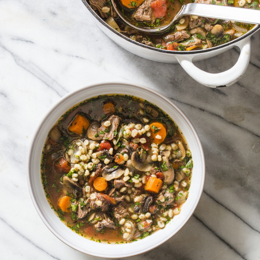 This undated photo provided by America’s Test Kitchen in September 2018 shows beef barley soup with mushrooms and thyme in Brookline, Mass.