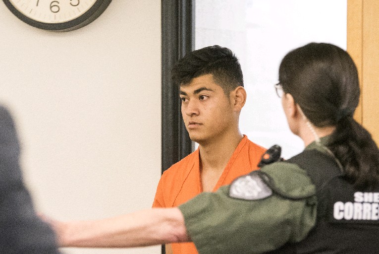 Erick Garcia-Valdovinos, 18, makes a first appearance Monday morning in Clark County Superior Court after being arrested on suspicion of two counts of first-degree kidnapping and one count of first-degree robbery.
