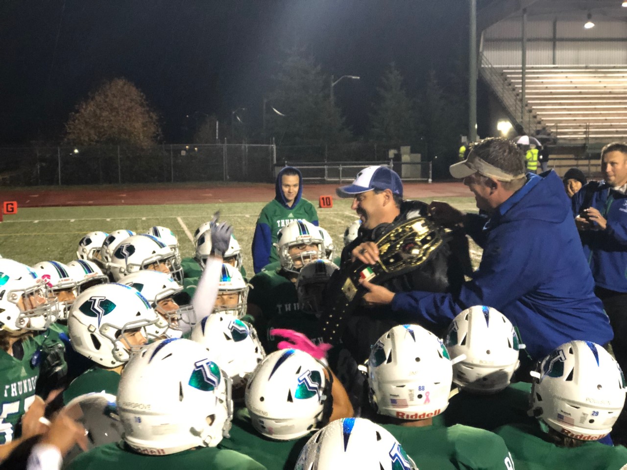 Mountain View coach Adam Mathieson carries the title belt after the Thunder finished first in the 3A Greater St. Helens League on Thursday, Oct. 25, 2018.