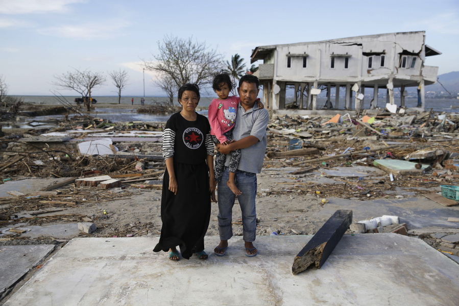 Musrifah, left, and her husband Hakim, right, and their daughter Syafa Ramadi pose where their house once stood before a massive earthquake and tsunami hit their seaside village in Palu, Central Sulawesi, Indonesia. The family lost their son. The 7.5 magnitude quake triggered not just a tsunami that leveled huge swathes of the region’s coast, but a geological phenomenon known as liquefaction, making the soil move like liquid and swallowing entire neighborhoods.