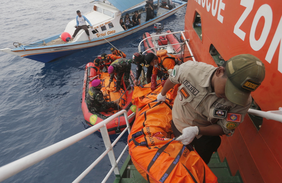 Rescuers load body bags containing debris and remains of the victims of the crashed Lion Air plane during a rescue operation in the waters of Tanjung Karawang, Indonesia, on Tuesday. Divers searched Tuesday for victims of the Lion Air plane crash and high-tech equipment was deployed to find its data recorders as reports emerged of problems on the jet’s previous flight that had terrified passengers.