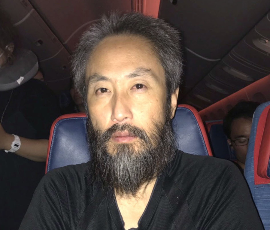 Japanese journalist Jumpei Yasuda is interviewed in a flight from Turkey to Japan. Yasuda returned to Tokyo on Thursday after being freed from more than three years of captivity in Syria.