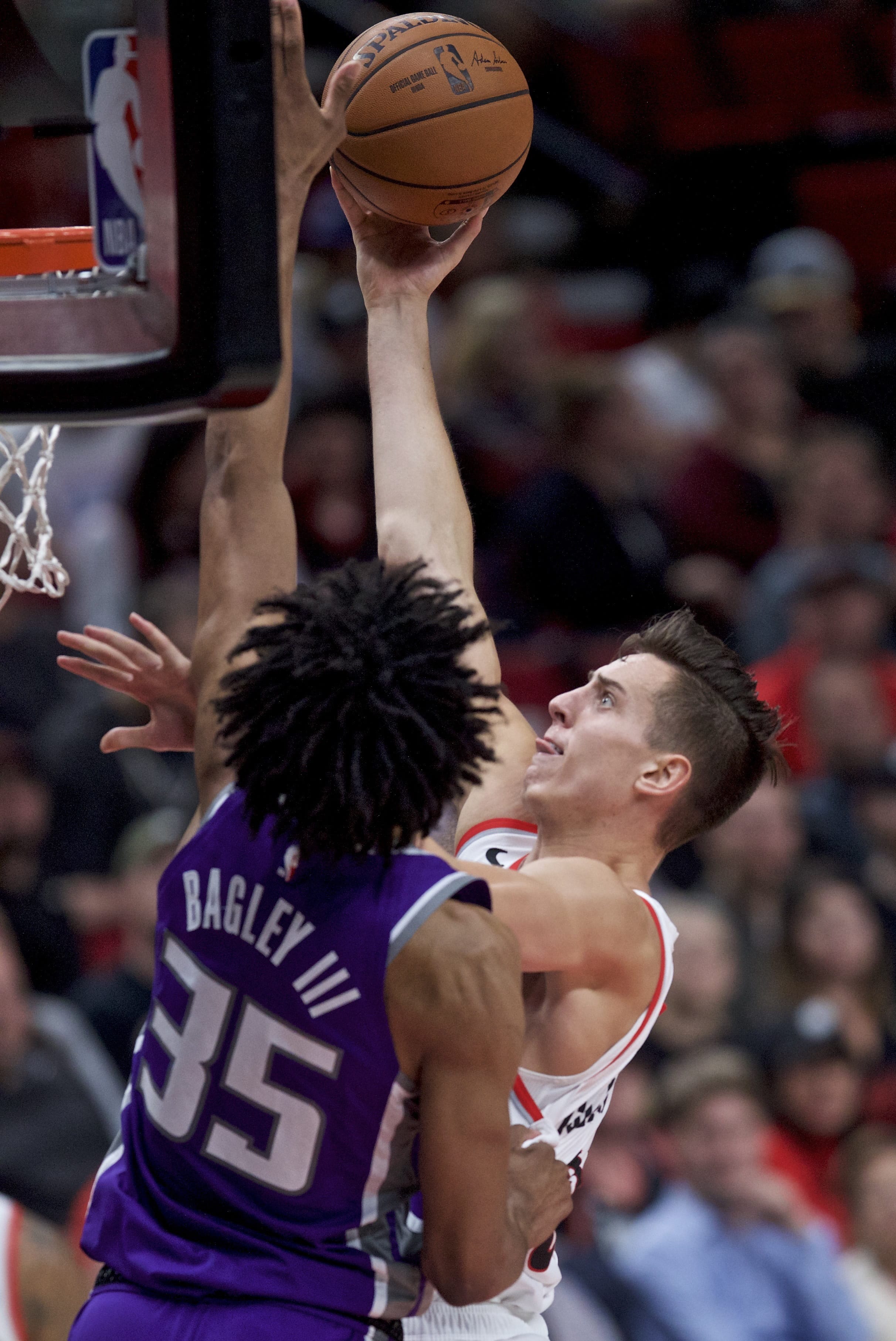 Portland Trail Blazers forward Zach Collins, right, shoots over Sacramento Kings forward Marvin Bagley III during the second half of an NBA preseason basketball game in Portland, Ore., Friday, Oct. 12, 2018.