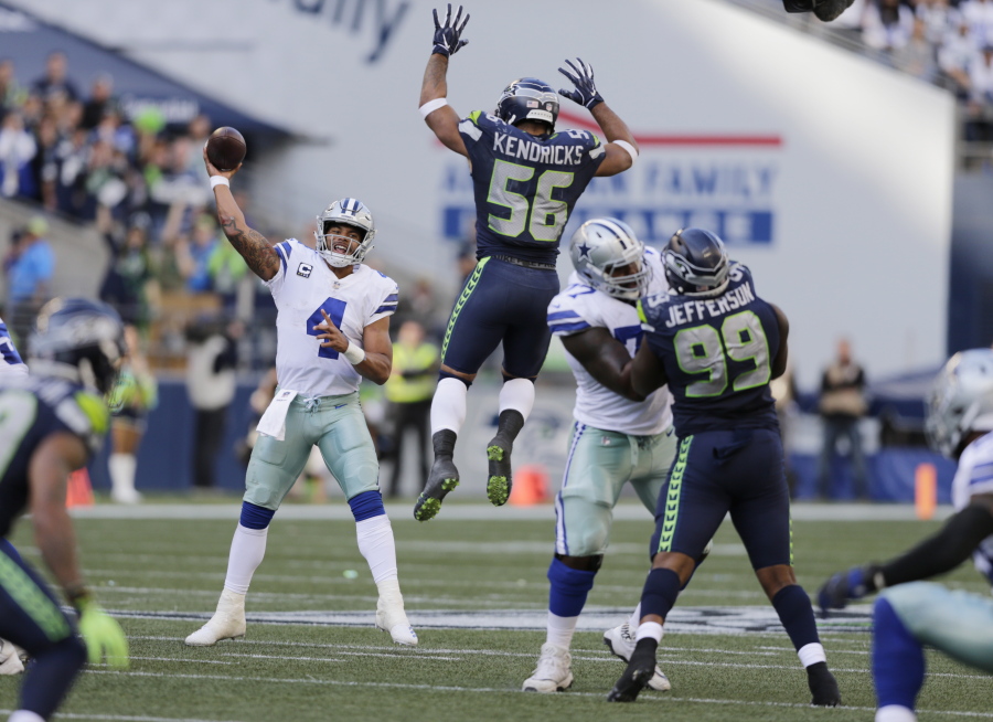 FILE - In this Sept. 23, 2018, file photo, Seattle Seahawks linebacker Mychal Kendricks (56) leaps as Dallas Cowboys quarterback Dak Prescott (4) attempts a pass during the second half of an NFL football game in Seattle. The Cowboys, who can’t find anything remotely resembling a rhythm with quarterback Dak Prescott and a new group of receivers, are at home this week against the Detroit Lions.