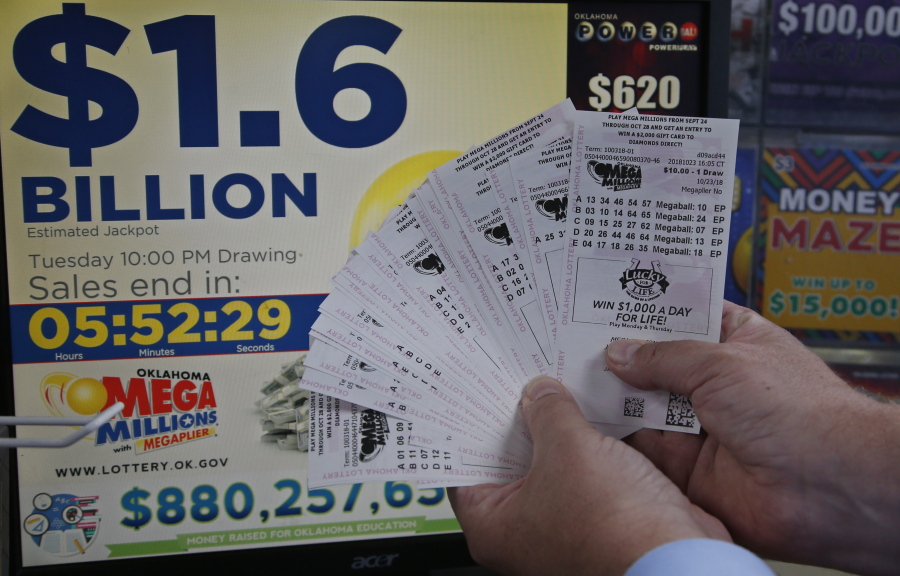A customer, who did not want to be identified, displays the $200 worth of Mega Millions tickets he bought at Downtown Plaza convenience store in Oklahoma City on Tuesday.