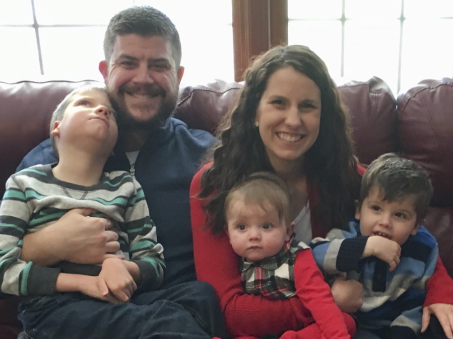 Jon and Kari Kilquist sit with their children, from left, Will, Emmy and Owen at their home in Murphysboro, Ill.